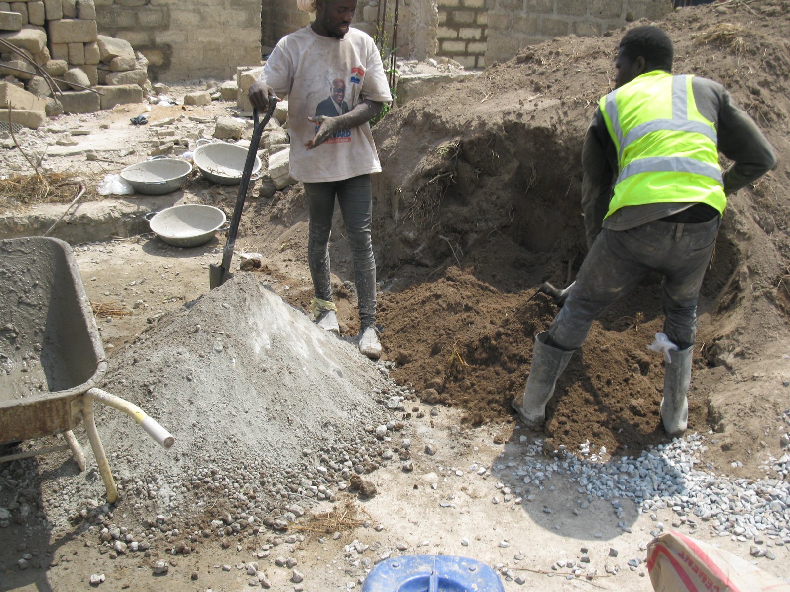 Construction workers mixing concrete in Ghana